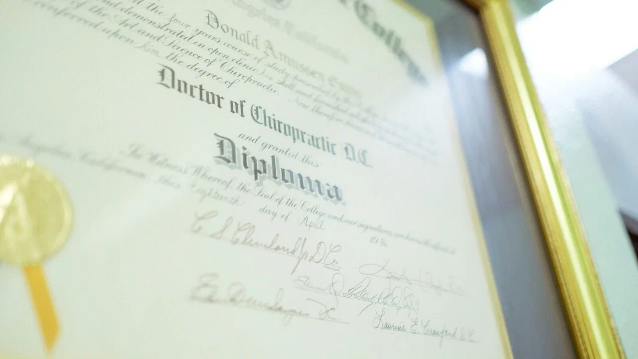 A framed certificate bearing an embossed gold seal